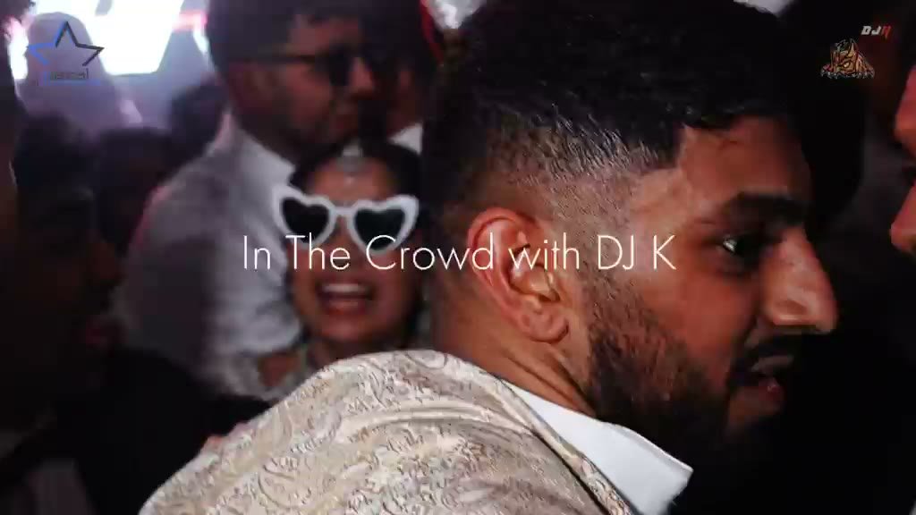 An energetic close-up of the dance floor, with guests singing together and the music bringing the room into one moment.