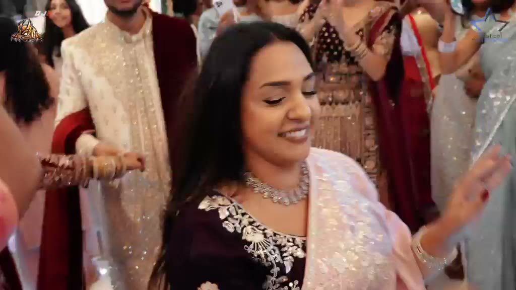 A bright, joyful wedding celebration with friends, family and the couple sharing the dance floor.